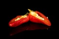 Hot pickled pepper isolated on black glass Royalty Free Stock Photo