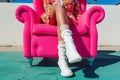 hot pink armchair, person in retro outfit, white gogo boots Royalty Free Stock Photo