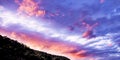 Hot pink colored cumulus cloud, sunset seascape.