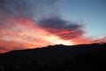 Hot pink and orange cotton candy dawn clouds over the mountains in Tucson Arizona Royalty Free Stock Photo