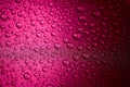 Hot pink water drops on a glitter surface, abstract macro photography Royalty Free Stock Photo