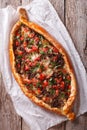 Hot pizza Turkish pide close up on the table. vertical top view Royalty Free Stock Photo