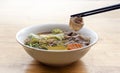 Hot pork boild with chopstick on noodle soup