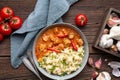 Hot pork goulash with chili, tomato and pepper, served with boiled dumplings topped with spring onion greens