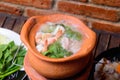 Hot pot with clear soup in the clay cooking pot. Royalty Free Stock Photo