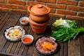 Hot pot with clear soup in the clay cooking pot. Royalty Free Stock Photo