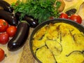 Hot ready moussaka in the form for baking among vegetables and s