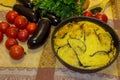 Hot ready moussaka in the form for baking among vegetables and s