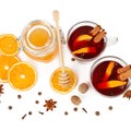 A Hot red mulled wine, bee honey, slices of oranges and spices isolated on white background. Flat lay, top view Royalty Free Stock Photo