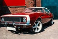 Hot red muscle car on brick wall background Royalty Free Stock Photo