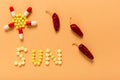 Word sun written with yellow pills as the concept of protection from allergy on the sun Royalty Free Stock Photo