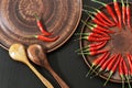 Hot red peppers in a clay pot on the kitchen table for cooking. The circle of spicy red chilli Royalty Free Stock Photo