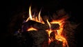 Hot roaring fire and red coals in fireplace. Burning wood in chimney wintertime Royalty Free Stock Photo