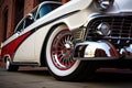 a hot rods shiny chrome wheel and whitewall tire close-up