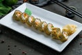 Hot roll with salmon and eel and cream cheese on dark stone table Royalty Free Stock Photo