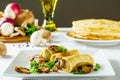 Hot Russian pancakes or blini with mushrooms.
