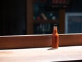 Hot sauce bottle sitting on table in outdoor dining area at restaurant Royalty Free Stock Photo