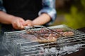 Hot sausage grilling outdoors on a barbecue grill Royalty Free Stock Photo