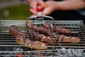 Hot sausage grilling outdoors on a barbecue grill Royalty Free Stock Photo