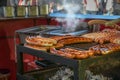 Hot sausages on a street grill, typical fast food on a German county fair or Christmas market, selected focus, narrow depth of