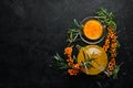 Hot sea buckthorn tea. Fresh sea buckthorn on a twig. Top view. Royalty Free Stock Photo