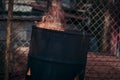 A hot fire in an old rusty iron barrel