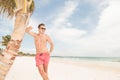 Hot lifeguard leaning on a tree Royalty Free Stock Photo