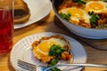 In hot shakshuka tomatoes sweet peppers eggs and herbs