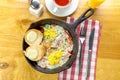 Hot skillet breakfast featuring eggs, ham, and toast served with drinks Royalty Free Stock Photo