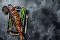 Hot smoked pike perch or zander fish in a wooden tray. Black background. Top view. Copy space