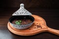 Hot snack Lobio `In Georgian` with celery in a ceramic pot at an oriental restaurant.