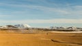 Hot soil in geothermic area surrounded by snowy mountains in North Iceland Royalty Free Stock Photo