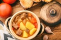 Hot soup goulash on brown wooden table. Royalty Free Stock Photo