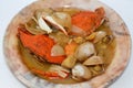 Hot soup meal of various fresh seafood marine crabs, shrimps, clams, mussels, gandofli, oysters, crab sticks, calamari, squid and Royalty Free Stock Photo