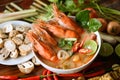 Hot and sour spicy shrimps prawns soup curry lemon lime galangal red chili straw mushroom on table food, Shrimp soup on seafood Royalty Free Stock Photo