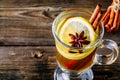 Hot spiced Apple cider Toddy with lemon, honey and cinnamon stick in glass Royalty Free Stock Photo