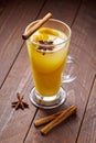 Hot spiced Toddy with lemon, honey and cinnamon stick in glass on wooden background. Royalty Free Stock Photo