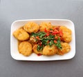 Hot and spicy basil nuggets on a white plate, fusion Thai food