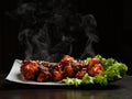 Hot and spicy bbq chicken wings with with green salad leaf and steam smoke Royalty Free Stock Photo