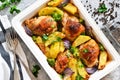 Hot spicy chicken with potatoes and broccoli baked. Concrete background. View from above Royalty Free Stock Photo