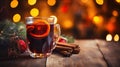 Hot spicy Christmas gluhwein, or mulled red wine with sugar and spices, served with cookies on rustic wood with a Royalty Free Stock Photo