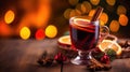 Hot spicy Christmas gluhwein, or mulled red wine with sugar and spices, served with cookies on rustic wood with a Royalty Free Stock Photo