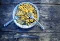 Hot and spicy cooked noodles served in steel plate and forks on wooden table Royalty Free Stock Photo