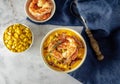 Hot spicy corn cream soup with bacon and shrimps. Royalty Free Stock Photo