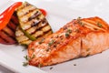 Hot and spicy fillet red fish. Grilled steak salmon or trout with grill paprika and zucchini. Healthy food, seafood and Royalty Free Stock Photo