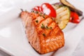 Hot and spicy fillet red fish. Grilled steak salmon or trout with grill paprika and zucchini. Healthy food, seafood and Royalty Free Stock Photo