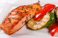 Hot and spicy fillet red fish. Grilled steak salmon or trout with grill paprika and zucchini. Healthy food, seafood and Royalty Free Stock Photo