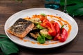 Hot and spicy fillet red fish. Grilled steak salmon or trout with grill paprika and zucchini. Healthy food Royalty Free Stock Photo