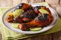 Hot spicy grilled chicken drumstick with lime and green onion cl