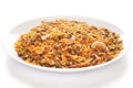 Hot spicy Kashmiri Mixture Namkeen snacks in a white ceramic plate made with dry fruits, peanuts, corn flakes, etc. Pile of Indi Royalty Free Stock Photo